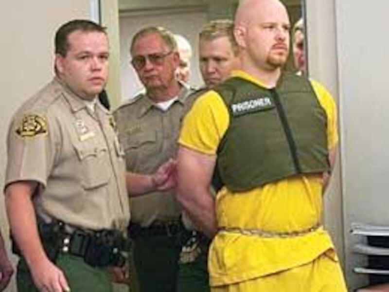 Mark Hacking, surrounded by Salt Lake County deputy sheriffs, enters Judge William Barrett's courtroom Thursday. He will next appear in court for arraignment on murder charges on Oct. 29. At that time, he will be expected to enter a plea.