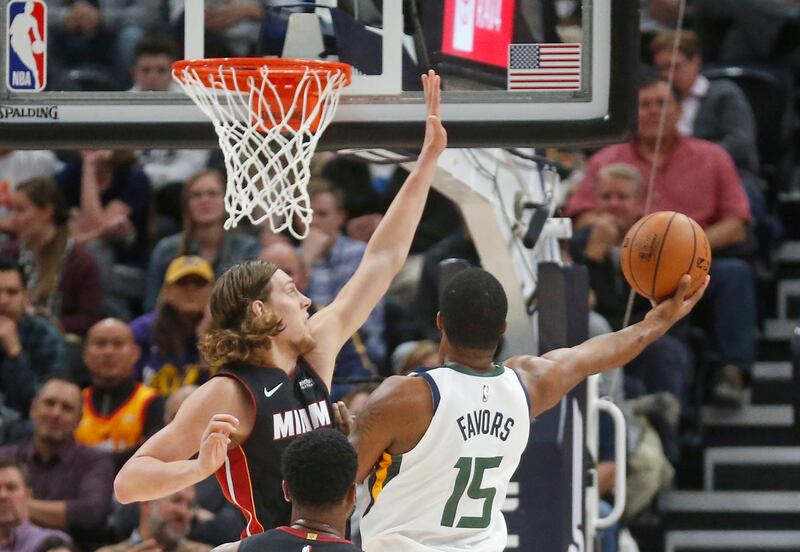 Utah Jazz forward Derrick Favors (15) lays the ball up as Miami Heat forward Kelly Olynyk, left, defends in the first half during an NBA basketball game Wednesday Dec. 12, 2018, in Salt Lake City. (AP Photo/Rick Bowmer)