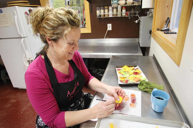 Ann Barraclough, owner of Aunt B's Cakes and Desserts, in Lake Ann, applies petal dust to gumpaste maple leaves, which will be used on a cake, Tuesday, Oct. 25, 2011. Area bakers will face off in six divisions in the competition when the Traverse City Fe