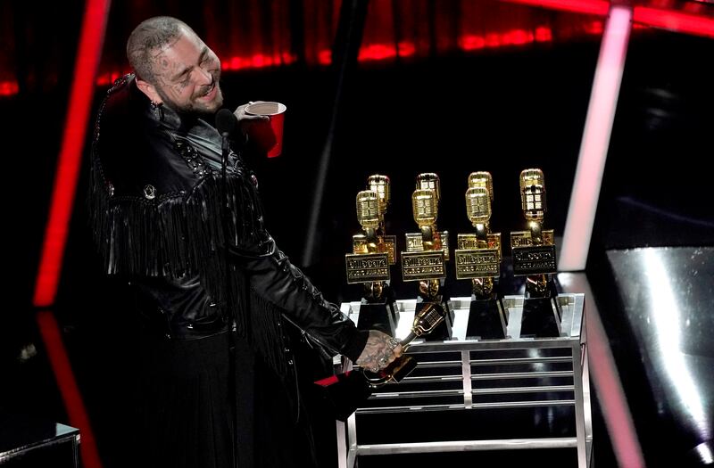 Post Malone appears on stage with his nine awards to include top male artist and top artist at the Billboard Music Awards on Wednesday, Oct. 14, 2020, at the Dolby Theatre in Los Angeles.