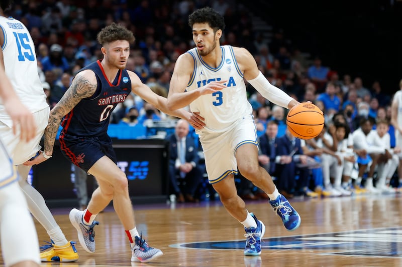 UCLA guard Johnny Juzang (3) drives around St. Mary’s guard Logan Johnson (0).
