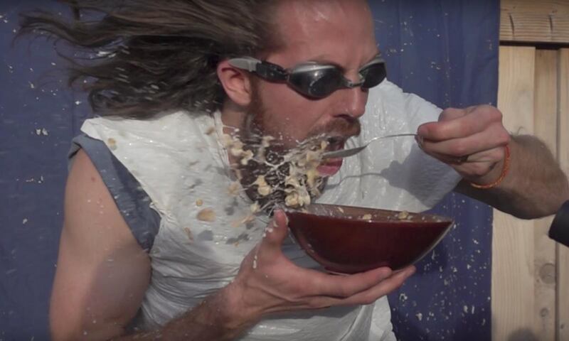 Bryce Jurgy attempts the leaf blower challenge while eating a bowl of cereal.