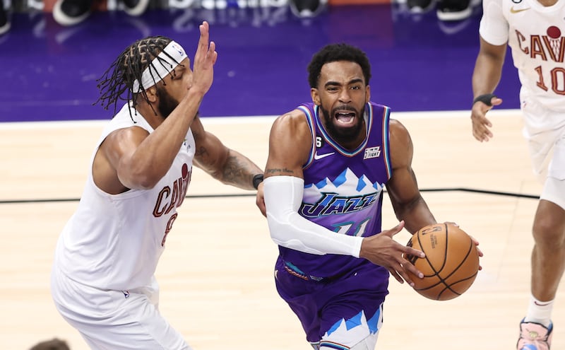 Utah Jazz guard Mike Conley (11) grimaces as he works against Cleveland Cavaliers forward Lamar Stevens (8) as the teams play at Vivint Arena in Salt Lake City on Tuesday, Jan. 10, 2023.