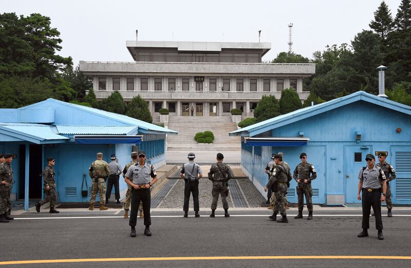 Soldiers of South Korea and the U.S. stand guard during a commemorative ceremony for the 64th anniversary of the signing of the Korean War Armistice Agreement at the truce village of Panmunjom in the Demilitarized Zone dividing the two Koreas.