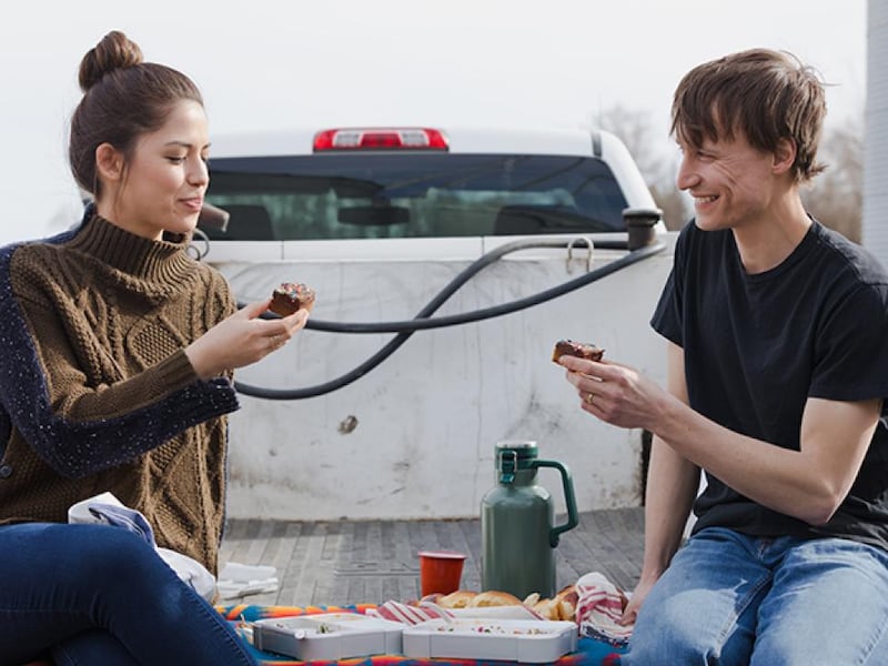 Molly Yeh and her husband Nick eat her Olive Oil Blondies during a lunch outdoors.