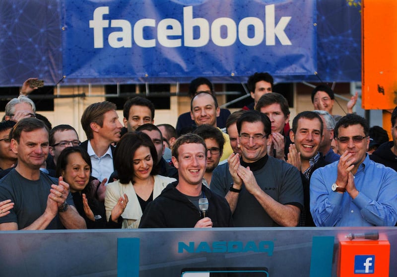 In this May 18, 2012 file photo provided by Facebook, Facebook founder, Chairman and CEO Mark Zuckerberg, center, rings the Nasdaq opening bell from Facebook headquarters in Menlo Park, Calif.