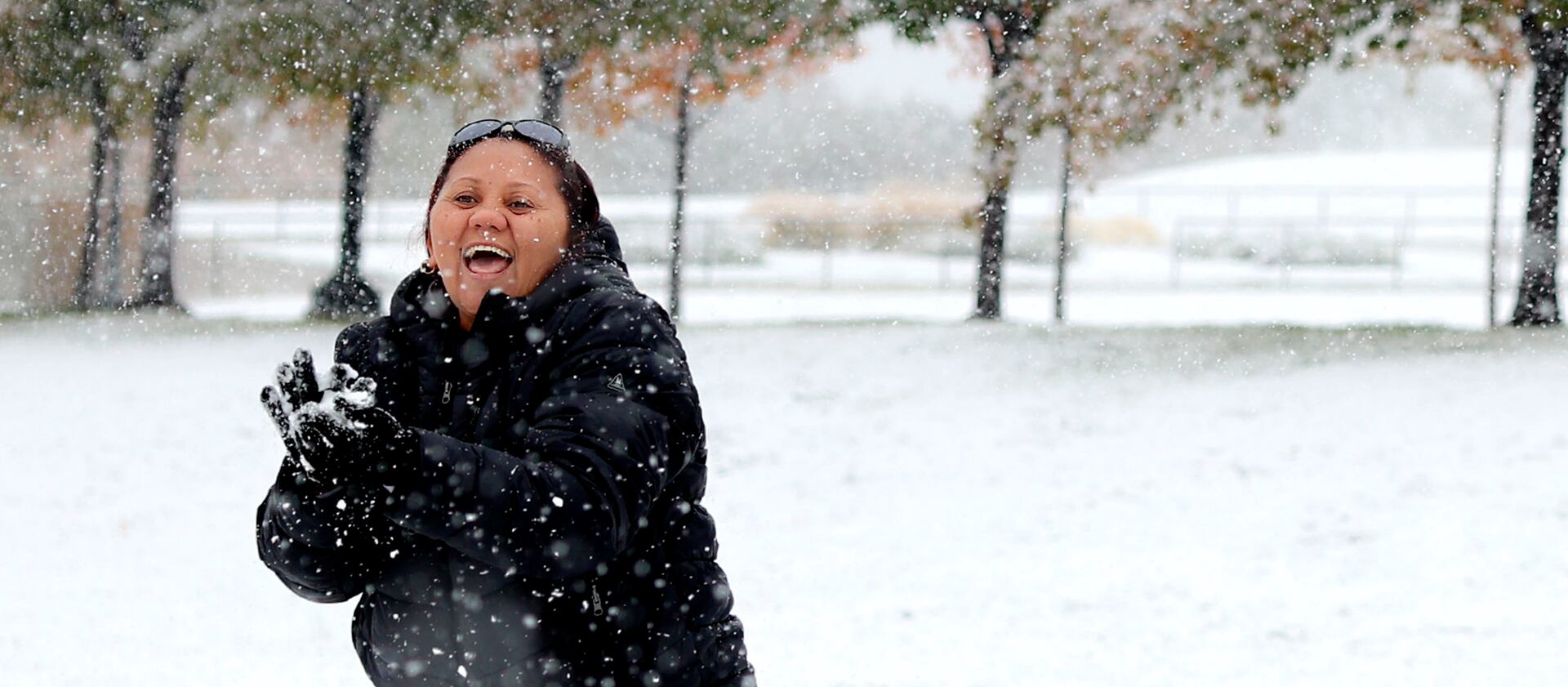 Carmen Gonzalez plays with snow for the first time in her life on the grounds of the Capitol in Salt Lake City.