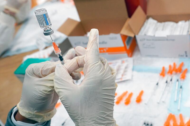 Registered nurse fills a syringe with the Johnson & Johnson COVID-19 vaccine.
