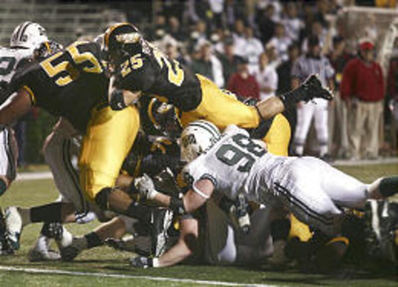 Southern Mississippi's Damion Fletcher (25) dives over Ohio University's Eric Kenkel (98) for a TD.