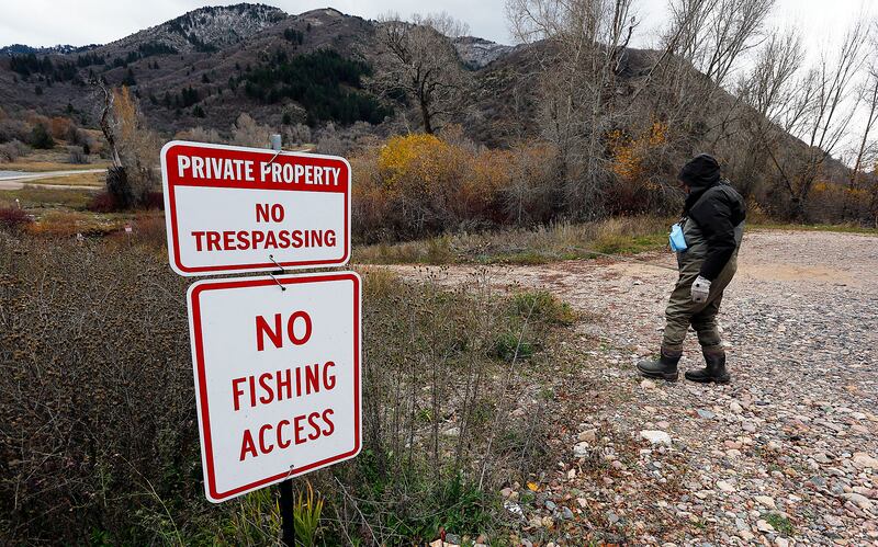 An angler walks to the Weber River to fish on Nov. 5, 2015.