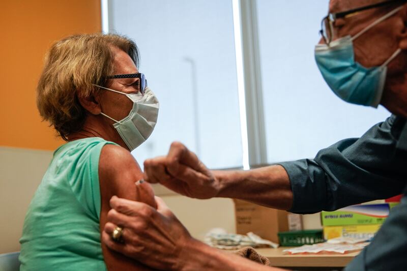 Minka Tasevac receives a Pfizer-BioNTech COVID-19 vaccine from by nurse Jon Hight at the Salt Lake Public Health Center on Sept. 30, 2021.