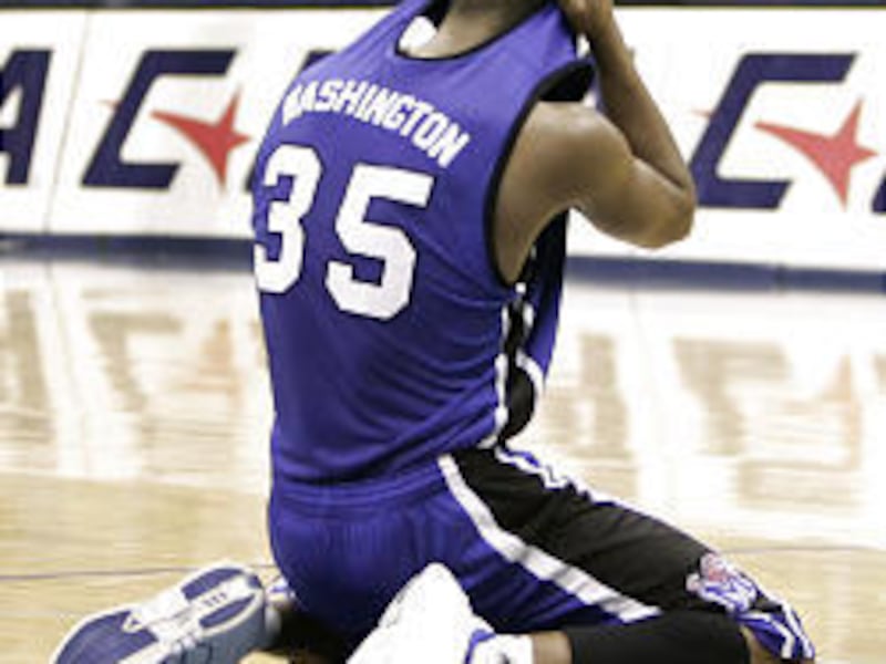 Darius Washington (35) of Memphis drops to the floor after the championship game of the C-USA tourney.