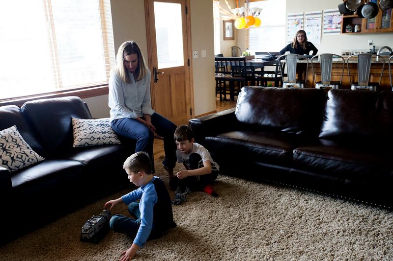 Andrea Greenwell watches Ryan Nelson and her son, Jonah Greenwell, play with Legos as her daughter, Lauren Greenwell, and Emery Nelson color after school at the Greenwell's home in Park City on Friday, March 16, 2018.