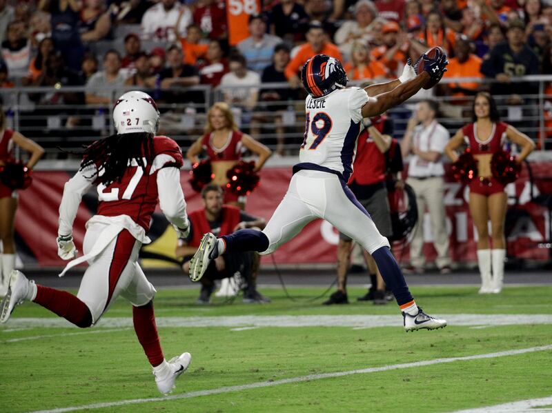 Denver Broncos wide receiver Jordan Leslie scores past Arizona Cardinals defensive back Travell Dixon during the second half of a preseason NFL football game Thursday, Aug. 30, 2018, in Glendale, Ariz. (AP Photo/Rick Scuteri)