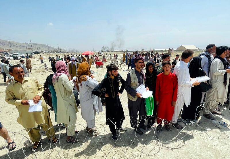 Hundreds of Afghans gather outside the airport in Kabul, Afghanistan, hoping to leave their country.