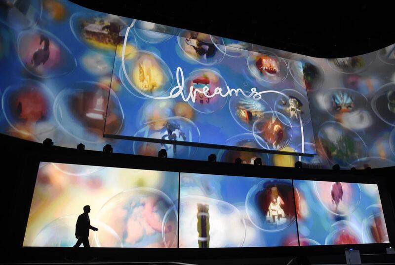 In this Monday, June 15, 2015 file photo, Asad Qizilbash, head of software marketing for Sony Computer Entertainment America, walks out onstage as graphics from the video game "Dreams" are displayed during the Sony Playstation at E3 2015 news conference a