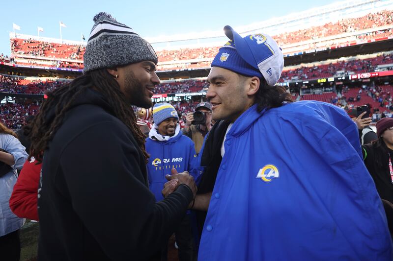 San Francisco 49ers linebacker Fred Warner, left, talks with Los Angeles Rams wide receiver Puka Nacua after an NFL game on Jan. 7, 2024.