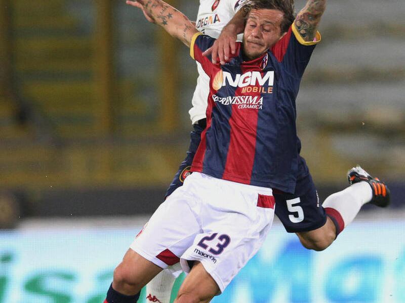 Bologna midfielder Alessandro Diamanti, foreground, and Cagliari midfielder Daniele Conti vie for the ball during their Italian Serie A soccer match at Bologna's Renato Dall'Ara stadium, Italy, Thursday April 12, 2012.