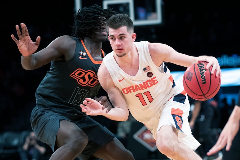 In this Wednesday, Nov. 27, 2019 file photo, Syracuse guard Joseph Girard III (11) drives against Oklahoma State guard Isaac Likekele (13) during the second half of an NCAA college semi final basketball game in the NIT Season Tip-Off tournament in New York. (AP Photo/Mary Altaffer, File)