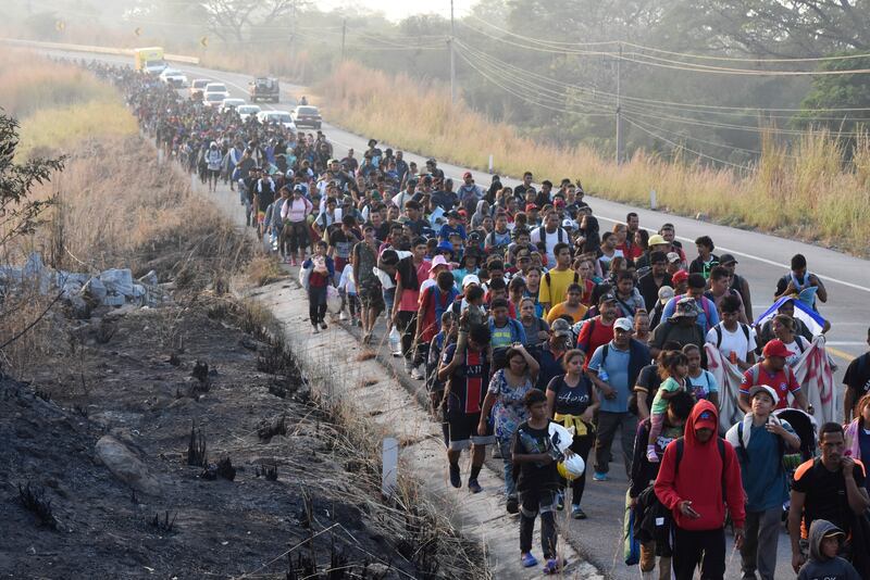 Migrants walk along the highway through Arriaga, Chiapas state in southern Mexico, on Jan. 8, 2024, during their journey north toward the U.S. border.