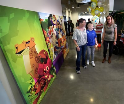 Kelly Moeller, left, and her daughter, Meagyn Moeller, 12, center, chat with Joy Gowans, of WildWorks, during a visit to the game development studio's offices in Draper on Thursday, Oct. 25, 2018. The Make-A-Wish Foundation flew Meagyn, who was diagnosed
