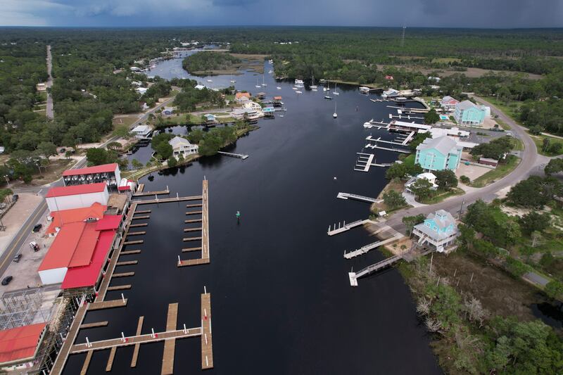 Storm clouds loom over riverfront homes and Sea Hag Marina in Steinhatchee, Fla.