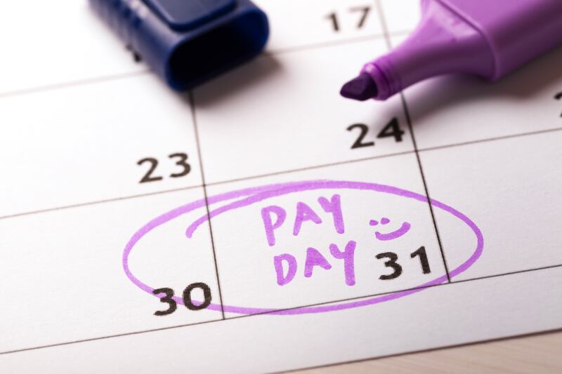 A Pay Day marking is circled in purple marker on a calendar.
