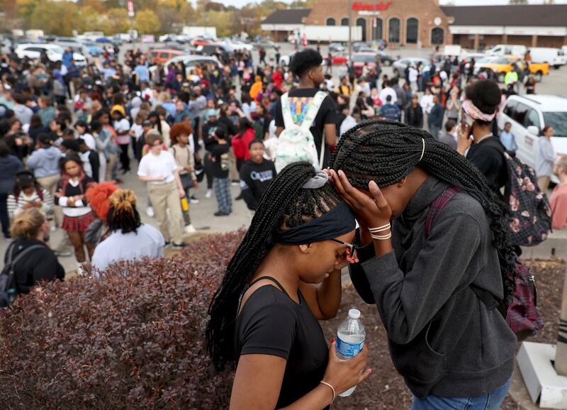 Students stand in a parking lot near the Central Visual & Performing Arts High School after a reported shooting at the school in St. Louis.
