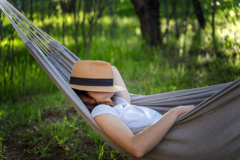A woman naps in a hammock. Twenty-minute naps have health benefits.