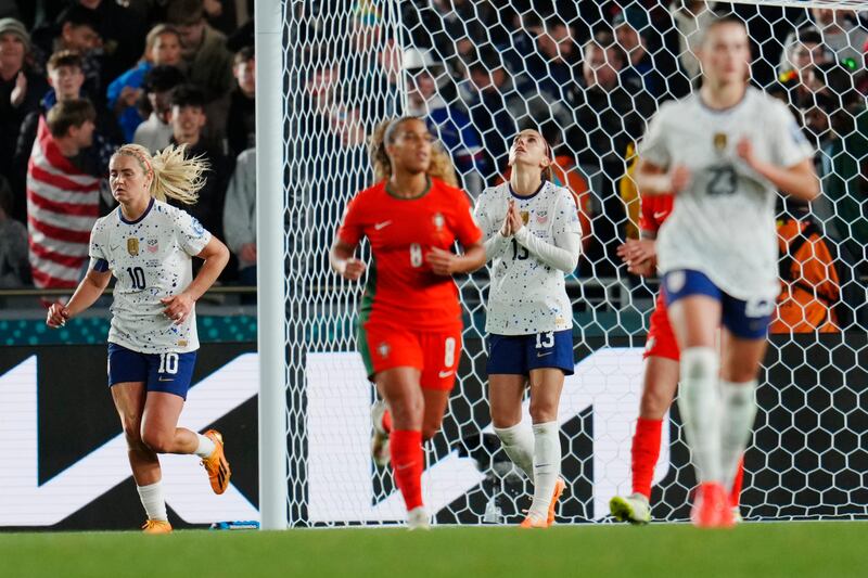 United States’ Alex Morgan, center, reacts after missing a shot during World Cup match between Portugal and the United States at Eden Park in Auckland, New Zealand, Tuesday, Aug. 1, 2023.