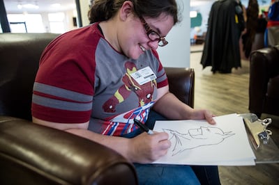 Lisa Hall sketches Batman during the Superhero Training Academy charity event hosted by the Rainy Days Foundation at the Ronald McDonald House in Salt Lake City on Sunday, Oct. 28, 2018.