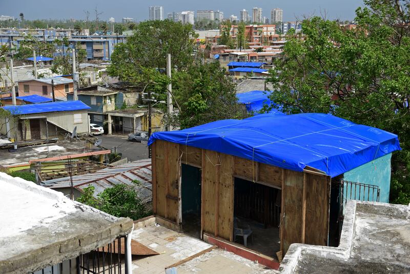 FILE - In this Oct. 19, 2017, file photo, homes in the Cantera area are covered with FEMA tarps, where buildings from the Hato Rey area stand in the background in San Juan, Puerto Rico. A U.S. lawmaker wants the Homeland Security Department’s inspector ge
