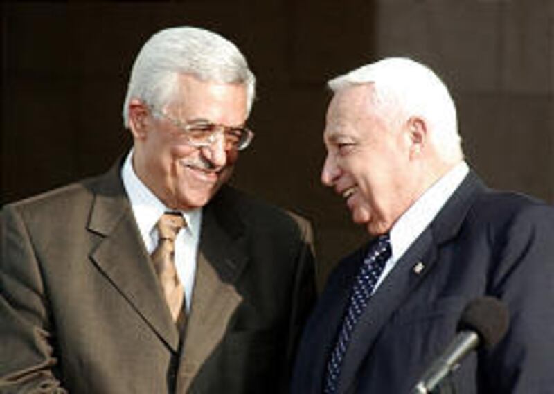 Then-Palestinian Prime Minister Mahmoud Abbas, left, and Israeli Prime Minister Ariel Sharon meet in Jerusalem in 2003. They will arrive in Egypt Tuesday for a summit.