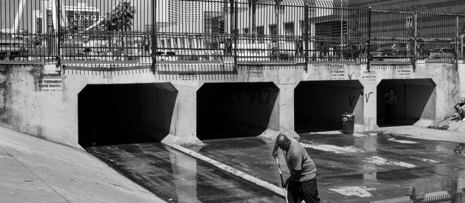 A man sweeps water from a tunnel near Caesars Palace in Las Vegas.