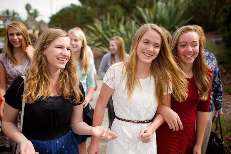 Young women walk together.