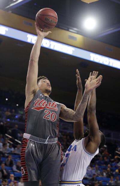 Utah forward Timmy Allen (20) shoots over UCLA's Prince Ali during the first half of an NCAA college basketball game Saturday, Feb. 9, 2019, in Los Angeles. (AP Photo/Marcio Jose Sanchez)