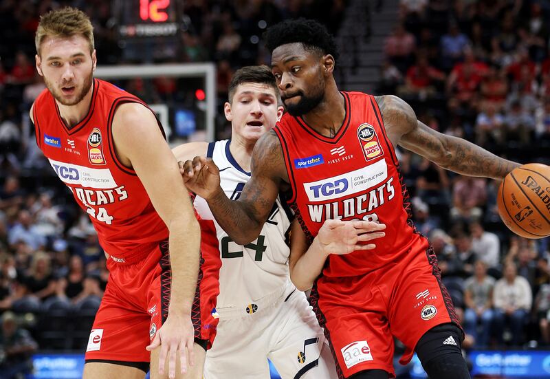 Perth Wildcats Eric Stuteville and Terrico White (23) squeeze out Utah Jazz guard Grayson Allen (24) as the Utah Jazz and the Perth Wildcats play in an exhibition basketball game at Vivint Smart Home Arena in Salt Lake City on Saturday, Sept. 29, 2018. Ja