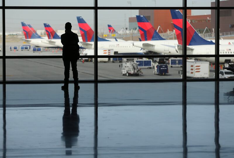 A man watches airplanes from the baggage claim area at the new Salt Lake City International Airport in Salt Lake City on Tuesday, Sept. 15, 2020.