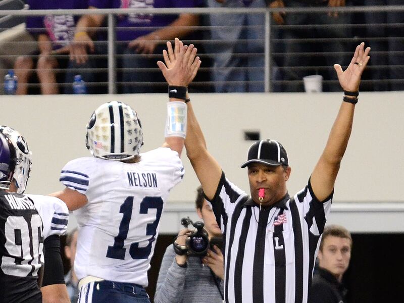 BYU’s Riley Nelson gives the referee a high-five after scoring during a game against TCU at Cowboys Stadium.