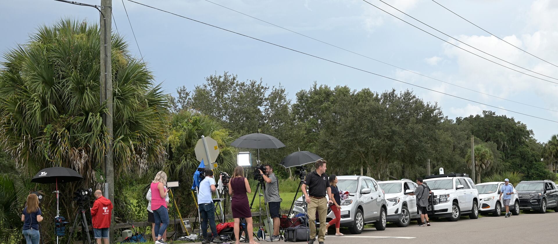 Vehicles line a road outside the entrance of the Carlton Reserve during a search for Brian Laundrie in Venice, Fla.
