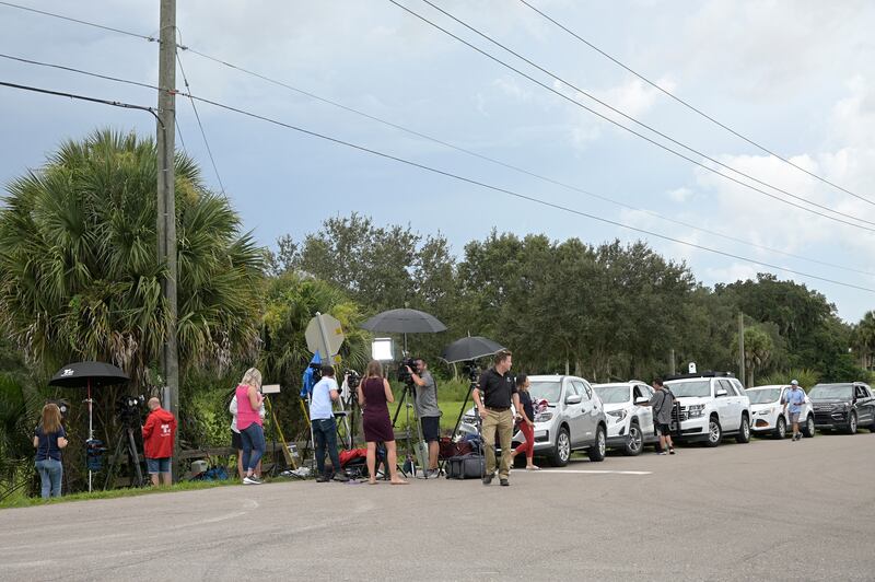 Vehicles line a road outside the entrance of the Carlton Reserve during a search for Brian Laundrie in Venice, Fla.