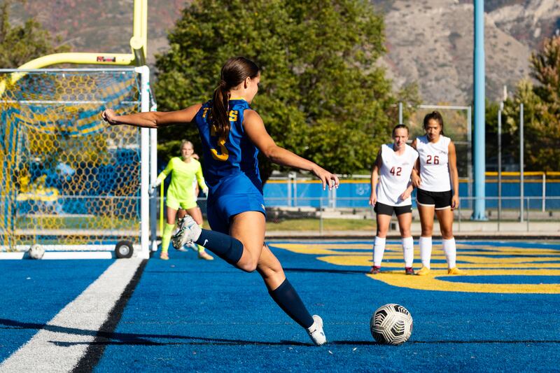 An Orem’s girls soccer player kicks the ball