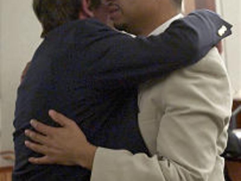 David Valken-Leduc, right, embraces his half-brother Sean Valken-Leduc after being found guilty of killing motel clerk Matthew John Whicker.