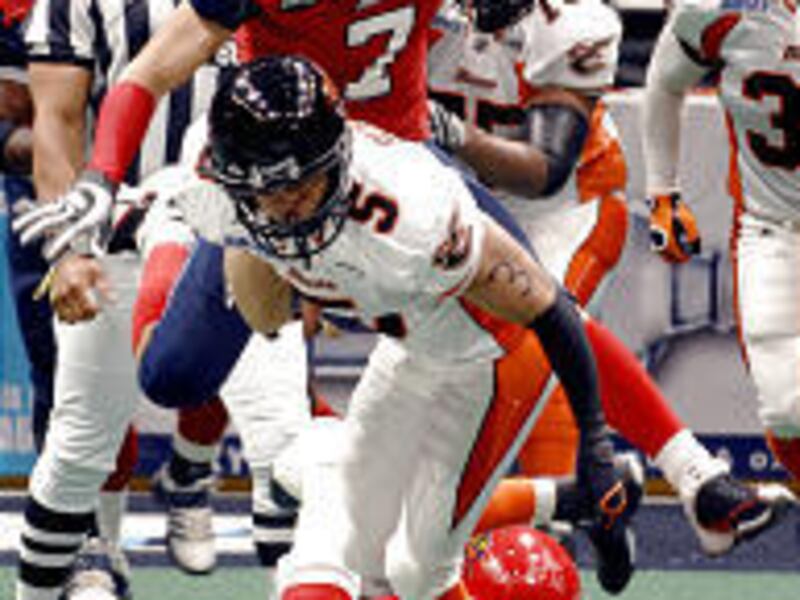 Utah's Siaha Burley is tackled after making a catch in the Blaze's 47-37 win.