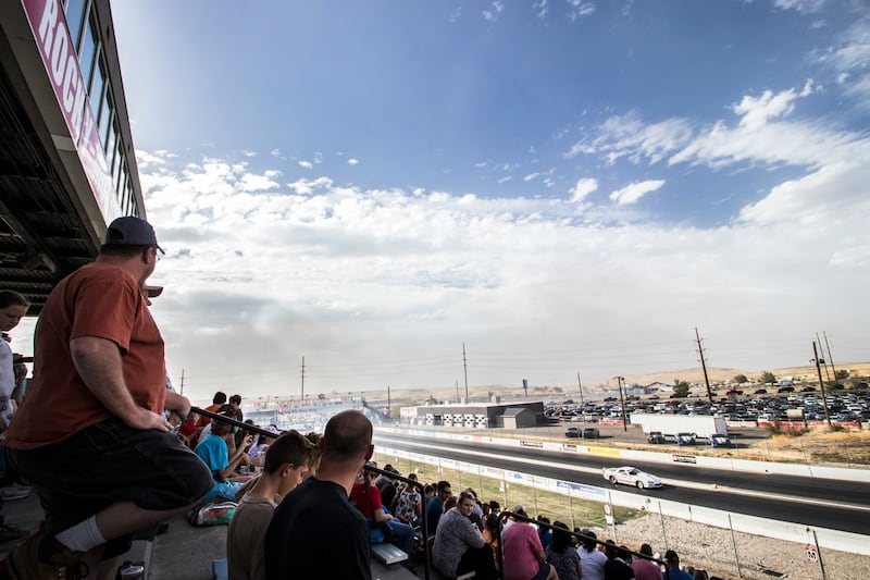 Fans watch as a vehicle races down the drag strip at Rocky Moutain Raceways on Saturday, Sept. 15, 2018. Rocky Mountain Raceways, which turned 50 this year, is shutting down after one last day of racing on Saturday.