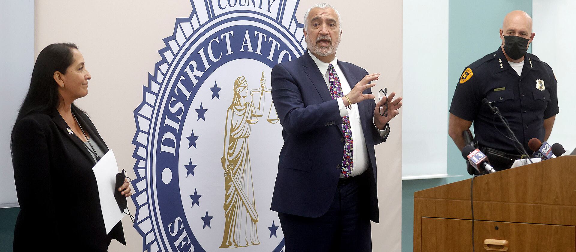 Salt Lake County Sheriff Rosie Rivera and Salt Lake City Police Chief Mike Brown listen to Salt Lake County District Attorney Sim Gill.