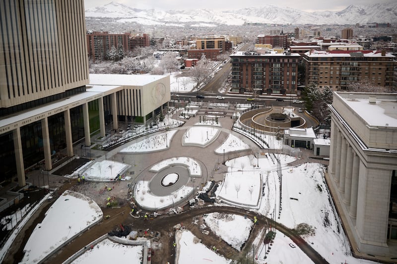 Workers install waterproofing and heating conduit under the Church Office Building plaza during the Temple Square renovation.