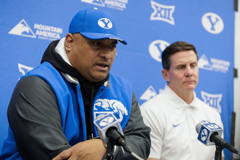 BYU coach Kalani Sitake, left, and defensive coordinator Jay Hill talk about new additions to the team on early signing day.