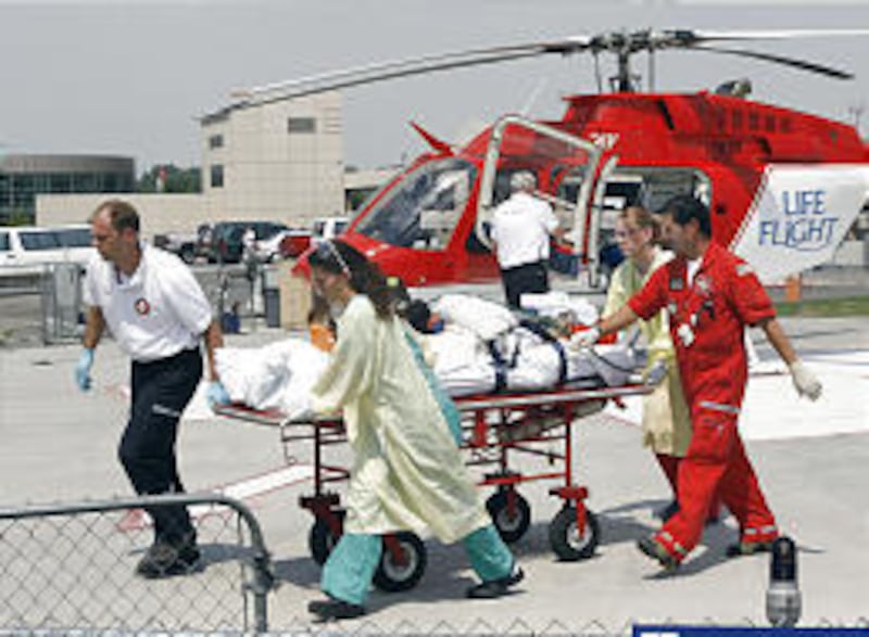 Life Flight and Utah Valley Regional Medical Center personnel transport a patient from helicopter to emergency room.