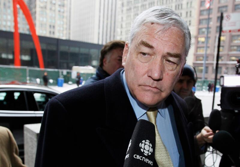 FILE - In this Jan. 13, 2011 file photo, Conrad Black arrives at the federal building in Chicago. President Donald Trump has granted a full pardon to Black, a former newspaper publisher who has written a flattering political biography of Trump. Black's me